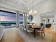 Elegant dining room with water views, decorative lighting, and modern furnishings at 8155 Midnight Pass Rd, Sarasota, FL 34242