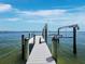 A well-maintained dock extends into the water, offering access for boating and waterfront enjoyment at 8155 Midnight Pass Rd, Sarasota, FL 34242