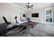 Modern exercise room with gym equipment, tile floor, and a large mirror with a view of the water at 8155 Midnight Pass Rd, Sarasota, FL 34242