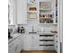 Functional pantry area with custom shelves, drawers, and a sink, creating an organized space at 8155 Midnight Pass Rd, Sarasota, FL 34242