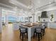 Bright, open kitchen featuring designer lighting, a center island, and seamless connection to the living area with water views at 8155 Midnight Pass Rd, Sarasota, FL 34242