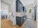 Well designed laundry room with blue cabinets, quartz countertops, and stainless steel appliances at 8155 Midnight Pass Rd, Sarasota, FL 34242