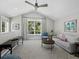 Bright living room with vaulted ceiling, large windows, and comfortable seating at 8155 Midnight Pass Rd, Sarasota, FL 34242