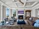 Cozy living space featuring a fireplace, elegant seating, and picturesque water views through large windows at 8155 Midnight Pass Rd, Sarasota, FL 34242