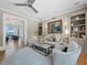 Comfortable living room with plush seating, built-in bookshelves, and water view at 8155 Midnight Pass Rd, Sarasota, FL 34242