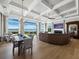 Spacious open-concept living area with a large sectional sofa, fireplace, and scenic water views at 8155 Midnight Pass Rd, Sarasota, FL 34242