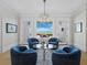 Elegant living room with comfortable blue chairs, stylish decor, and stunning views of the waterfront at 8155 Midnight Pass Rd, Sarasota, FL 34242