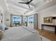 Bright main bedroom featuring tray ceiling, water views, and stylish decor at 8155 Midnight Pass Rd, Sarasota, FL 34242
