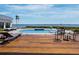 Backyard pool with spa, water views, and outdoor seating at 8155 Midnight Pass Rd, Sarasota, FL 34242