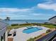 Backyard pool with a hot tub and bay views, along with outdoor seating at 8155 Midnight Pass Rd, Sarasota, FL 34242