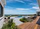 Backyard oasis with pool, lounge chairs, and serene water view at 8155 Midnight Pass Rd, Sarasota, FL 34242