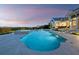 Stunning backyard pool and spa with sleek tile, set against a beautiful home and serene water view at 8155 Midnight Pass Rd, Sarasota, FL 34242