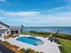 Backyard pool and patio overlooking the bay, with an outdoor dining area and lounge furniture at 8155 Midnight Pass Rd, Sarasota, FL 34242