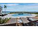 Stunning pool area features a spa and overlooks a picturesque waterfront view, perfect for relaxation and entertaining at 8155 Midnight Pass Rd, Sarasota, FL 34242