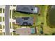 An aerial view shows backyard pools and solar panels on roof of this residential home at 8355 Velda Trl, Sarasota, FL 34241