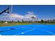 Community basketball court under a sunny sky, complemented by palm trees and greenery for recreation at 8355 Velda Trl, Sarasota, FL 34241