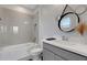 Bright bathroom featuring modern vanity, subway tile, and combined tub and shower at 8355 Velda Trl, Sarasota, FL 34241