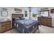 Comfortable bedroom with wood furniture and cozy bedding. Features ample light at 8355 Velda Trl, Sarasota, FL 34241