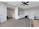 Bright bonus room with grey walls, neutral carpet, ceiling fan, and white sofa at 8355 Velda Trl, Sarasota, FL 34241