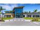 Modern clubhouse exterior showcasing a sleek design with ample windows and landscaping at 8355 Velda Trl, Sarasota, FL 34241