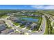 Aerial view of a community with lake view homes at 8355 Velda Trl, Sarasota, FL 34241