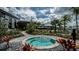 Community hot tub surrounded by lush landscaping and lounge chairs for relaxation at 8355 Velda Trl, Sarasota, FL 34241