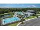 Community pool with lounge chairs, tables and umbrellas offering a refreshing outdoor space at 8355 Velda Trl, Sarasota, FL 34241