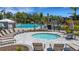 Community pool with lounge chairs and hot tub offering a relaxing outdoor space at 8355 Velda Trl, Sarasota, FL 34241