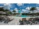 View of community pool with slide and splash area, plus lounge chairs and umbrellas by the pool at 8355 Velda Trl, Sarasota, FL 34241