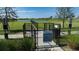 A fenced dog park with lush landscaping and a lake nearby at 8355 Velda Trl, Sarasota, FL 34241