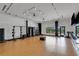 Spacious gym with wood floors, modern equipment, and ample natural light at 8355 Velda Trl, Sarasota, FL 34241