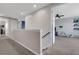 Upstairs hallway featuring access to multiple rooms and neutral paint, providing seamless flow throughout the home at 8355 Velda Trl, Sarasota, FL 34241