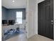 Home office featuring blue accent wall, a modern desk, and a view through the door to the entry at 8355 Velda Trl, Sarasota, FL 34241