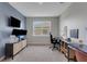Functional home office boasts neutral walls, carpeting, and a window with lots of desk space at 8355 Velda Trl, Sarasota, FL 34241