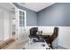 Comfortable home office with a white door, tiled floor, and a modern office chair at 8355 Velda Trl, Sarasota, FL 34241