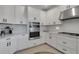 Elegant white kitchen featuring stainless appliances and ample counter space at 8355 Velda Trl, Sarasota, FL 34241