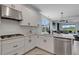 Modern kitchen featuring stainless steel appliances, granite countertops, and an island at 8355 Velda Trl, Sarasota, FL 34241