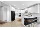 Modern kitchen featuring white cabinets, a contrasting black refrigerator, and a center island with barstool seating at 8355 Velda Trl, Sarasota, FL 34241