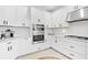 Modern kitchen design featuring stainless steel appliances and sleek white cabinetry at 8355 Velda Trl, Sarasota, FL 34241