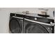 Modern laundry room featuring side-by-side Samsung washer and dryer at 8355 Velda Trl, Sarasota, FL 34241