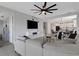 Open-concept living room with a modern ceiling fan, TV, and access to kitchen at 8355 Velda Trl, Sarasota, FL 34241