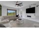 Bright living room features a large sectional sofa and modern ceiling fan at 8355 Velda Trl, Sarasota, FL 34241