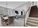 Open-concept home with dining area, staircase, and living room at 8355 Velda Trl, Sarasota, FL 34241