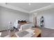 Comfortable main bedroom featuring stylish decor, tray ceiling and neutral colors at 8355 Velda Trl, Sarasota, FL 34241