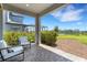 Outdoor patio with views of the lake and green space, featuring comfortable seating at 8355 Velda Trl, Sarasota, FL 34241