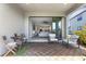Covered patio with outdoor seating opens to an expansive living area and offers natural light at 8355 Velda Trl, Sarasota, FL 34241