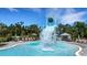 Fun splash pad with dumping bucket and slide, surrounded by lounge chairs for a relaxing poolside experience at 8355 Velda Trl, Sarasota, FL 34241