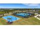 An aerial view of blue sports courts with mature palm trees on a sunny day at 8355 Velda Trl, Sarasota, FL 34241