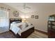 Cozy bedroom features a queen-sized bed, hardwood floors, and natural light from window with sheer curtains at 8404 Imperial Cir # 8404, Palmetto, FL 34221