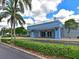 Community clubhouse exterior showcasing well-manicured landscaping and covered entryway with adjacent parking at 8404 Imperial Cir # 8404, Palmetto, FL 34221